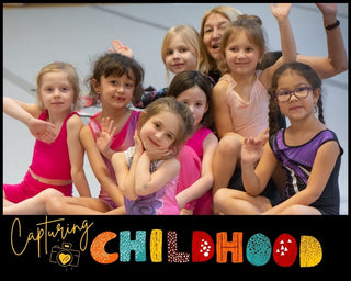 Family Event Photography example: preschool-aged rhythmic gymnasts and their coach during practice at the Cleveland School of Rhythmic Art. Children, smile and pose energetically, capturing the joy of their gymnastics training. Photo by Lena Moro