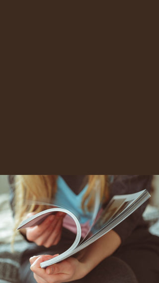 Person holding a book with a blurred background