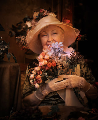 Lena Moro's fine art photo showcases a smiling mature woman with flowers in a soft, natural brown color palette