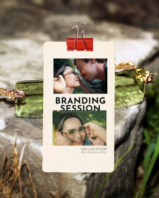Promotional card for a branding session with a couple and a woman wearing sunglasses, attached to a rock with a red clip.