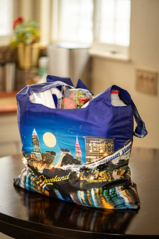 Blue tote bag with Cleveland skyline design on a kitchen counter